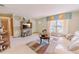 Inviting living room with large windows, a view of the front yard, and a comfortable sofa at 6449 Eve St, St Cloud, FL 34771