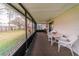 Spacious screened porch with outdoor seating and views of the lush backyard at 6449 Eve St, St Cloud, FL 34771