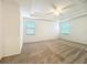 Spacious bedroom with tray ceilings and carpeted floors at 6974 Trellis Vine Loop, Windermere, FL 34786