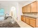 Modern kitchen showcases granite countertops, stainless steel sink, and abundant wood cabinetry at 6974 Trellis Vine Loop, Windermere, FL 34786