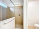 Tiled shower behind a glass door features chrome hardware and a window for natural light at 6974 Trellis Vine Loop, Windermere, FL 34786