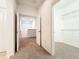 Upstairs hallway with open doors to bedroom and walk-in closet at 6974 Trellis Vine Loop, Windermere, FL 34786