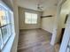 Bright, empty bedroom featuring laminate flooring, a ceiling fan, and natural light at 8137 Claire Ann Dr # 203, Orlando, FL 32825