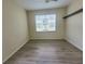 Unfurnished bedroom with laminate flooring, ceiling fan, and sunny window at 8137 Claire Ann Dr # 203, Orlando, FL 32825