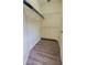 Walk-in closet with laminate flooring and shelving for organized storage solutions at 8137 Claire Ann Dr # 203, Orlando, FL 32825
