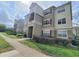 Exterior view of the condo building featuring well-maintained landscaping and a welcoming entrance area at 8137 Claire Ann Dr # 203, Orlando, FL 32825