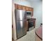 The kitchen includes stainless steel appliances such as a refrigerator, microwave, and oven at 8137 Claire Ann Dr # 203, Orlando, FL 32825