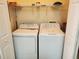 This laundry room includes a washer, a dryer, and wire shelving at 8137 Claire Ann Dr # 203, Orlando, FL 32825