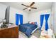 Bright bedroom with blue curtains, laminate flooring, and double windows at 1006 San Domingo Rd, Orlando, FL 32808