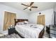 Bedroom features a ceiling fan, laminate flooring, and a large bed at 1006 San Domingo Rd, Orlando, FL 32808