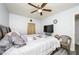 Bedroom features a ceiling fan, laminate flooring, and a large bed with soft pillows at 1006 San Domingo Rd, Orlando, FL 32808