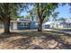 A quaint single-story home with a covered parking area and mature trees at 1006 San Domingo Rd, Orlando, FL 32808