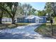 Cozy single-story home with a covered parking area and mature trees at 1006 San Domingo Rd, Orlando, FL 32808