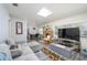 Open concept living room with natural light, stone fireplace, and access to the dining area at 1006 San Domingo Rd, Orlando, FL 32808