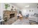 Cozy living room with stone fireplace, wood-look flooring, and comfortable seating at 1006 San Domingo Rd, Orlando, FL 32808