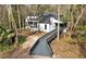 An inviting two-story home with a walkway surrounded by lush trees at 104 Wild Plum Ln, Longwood, FL 32779