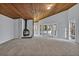 Bright living room featuring a wood ceiling, fireplace, and walls of windows for natural light at 104 Wild Plum Ln, Longwood, FL 32779