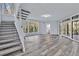 Open floor plan with staircase, large windows and doors to deck offer bright, airy living space at 104 Wild Plum Ln, Longwood, FL 32779