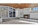 Living room boasting a warm fireplace, wood ceiling and wall of windows for natural light at 104 Wild Plum Ln, Longwood, FL 32779