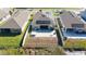 Aerial view of the home, backyard with hot tub, and solar panels at 1097 Hendon Loop, Davenport, FL 33837