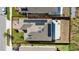 Aerial view showcases the roof with solar panels, backyard basketball court, and fenced lawn at 1097 Hendon Loop, Davenport, FL 33837