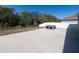 View of backyard with concrete pad and portable hot tub at 1097 Hendon Loop, Davenport, FL 33837