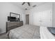 Well-lit bedroom with a bed, dresser with television, and a window with natural light at 1097 Hendon Loop, Davenport, FL 33837