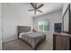 Comfortable bedroom featuring a bed, nightstand, and a window with natural light at 1097 Hendon Loop, Davenport, FL 33837