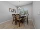 Dining area with a chandelier, wooden table, and upholstered chairs under a window at 1097 Hendon Loop, Davenport, FL 33837