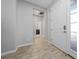 Inviting entryway with tile floors, neutral walls, and views of a bathroom down the hall at 1097 Hendon Loop, Davenport, FL 33837