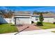 Charming single-Gathering home featuring a well-maintained lawn, brick driveway, and two-car garage at 1097 Hendon Loop, Davenport, FL 33837