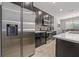 Modern kitchen with dark cabinetry, stainless steel appliances, and tile backsplash at 1097 Hendon Loop, Davenport, FL 33837