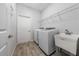 Well-lit laundry room featuring modern appliances and a utility sink for added convenience at 1097 Hendon Loop, Davenport, FL 33837