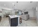 Open-concept living area featuring a kitchen island, dining area, and living space with a ceiling fan at 1097 Hendon Loop, Davenport, FL 33837
