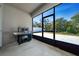 Screened patio has stainless steel grill and view of yard at 1097 Hendon Loop, Davenport, FL 33837