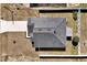 A bird's-eye view reveals the home's solar panels, fenced yard, and proximity to a paved driveway at 1238 James Ln, Kissimmee, FL 34759