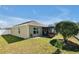An inviting backyard featuring a screened lanai and well-maintained lawn offers relaxation and outdoor enjoyment at 1238 James Ln, Kissimmee, FL 34759