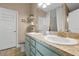 Well-lit bathroom with double vanity sinks, stylish countertops, storage, and modern fixtures for added convenience at 1238 James Ln, Kissimmee, FL 34759