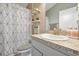 Bathroom vanity with white cabinets, a granite counter, and decorative shelves with decor at 1238 James Ln, Kissimmee, FL 34759