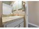 Bathroom vanity featuring a granite counter, white cabinets, and gold fixtures at 1238 James Ln, Kissimmee, FL 34759