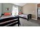 Bedroom featuring two twin beds, bedside tables with lamps, and natural lighting at 1238 James Ln, Kissimmee, FL 34759
