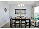 Formal dining room with modern lighting, a decorative mirror, table with seating for six, and stylish decor at 1238 James Ln, Kissimmee, FL 34759