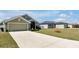 A single-story home with a long driveway and well-manicured lawn at 1238 James Ln, Kissimmee, FL 34759