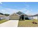 Charming single-story home with well-maintained lawn and a two-car garage at 1238 James Ln, Kissimmee, FL 34759