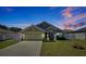 Charming home featuring a two-car garage, landscaped front yard, and a freshly sealed driveway at 1238 James Ln, Kissimmee, FL 34759