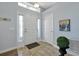 Bright foyer with white door, light blue walls, and decorative plant at 1238 James Ln, Kissimmee, FL 34759