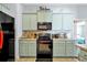 Charming kitchen featuring modern appliances and ample cabinet space with pleasing backsplash and countertops at 1238 James Ln, Kissimmee, FL 34759