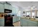 Bright kitchen with a stylish island, stainless steel appliances, tile backsplash, and easy access to living space at 1238 James Ln, Kissimmee, FL 34759