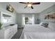 Comfortable main bedroom with a large window, dresser, ceiling fan, and neutral tones for a peaceful retreat at 1238 James Ln, Kissimmee, FL 34759