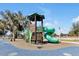 Colorful playground with slides, climbing structures, and soft, safe ground covering for fun and active play at 1238 James Ln, Kissimmee, FL 34759